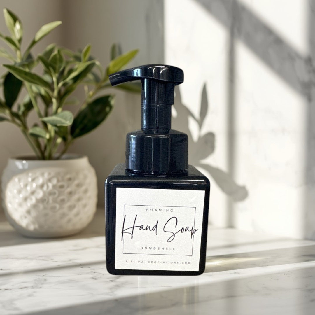 Doodlations Coffee Bar & Boutique Bombshell foaming hand soap in a black square bottle with a white label.