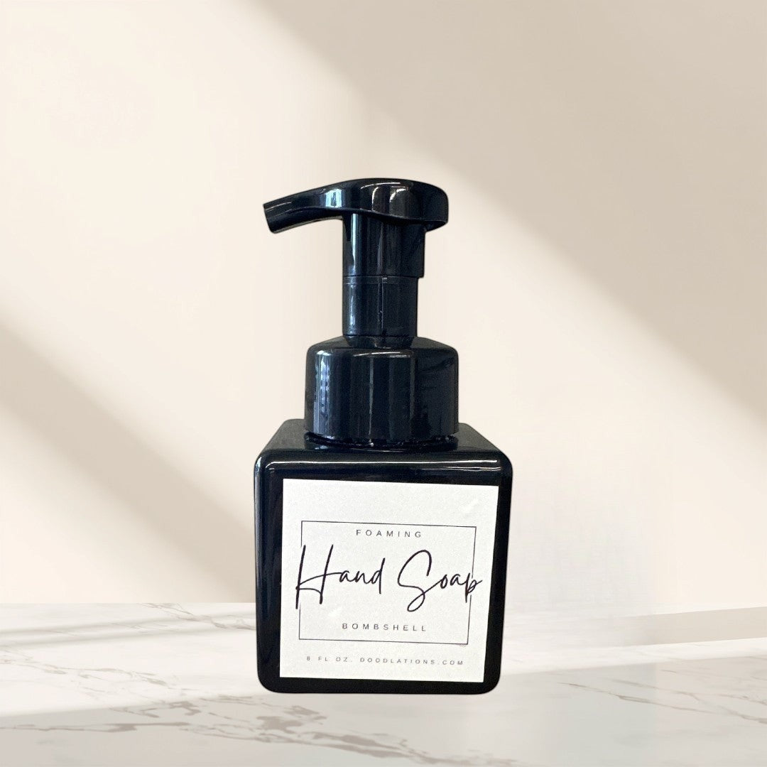 Doodlations Bombshell foaming hand soap in a black square bottle with a white label.