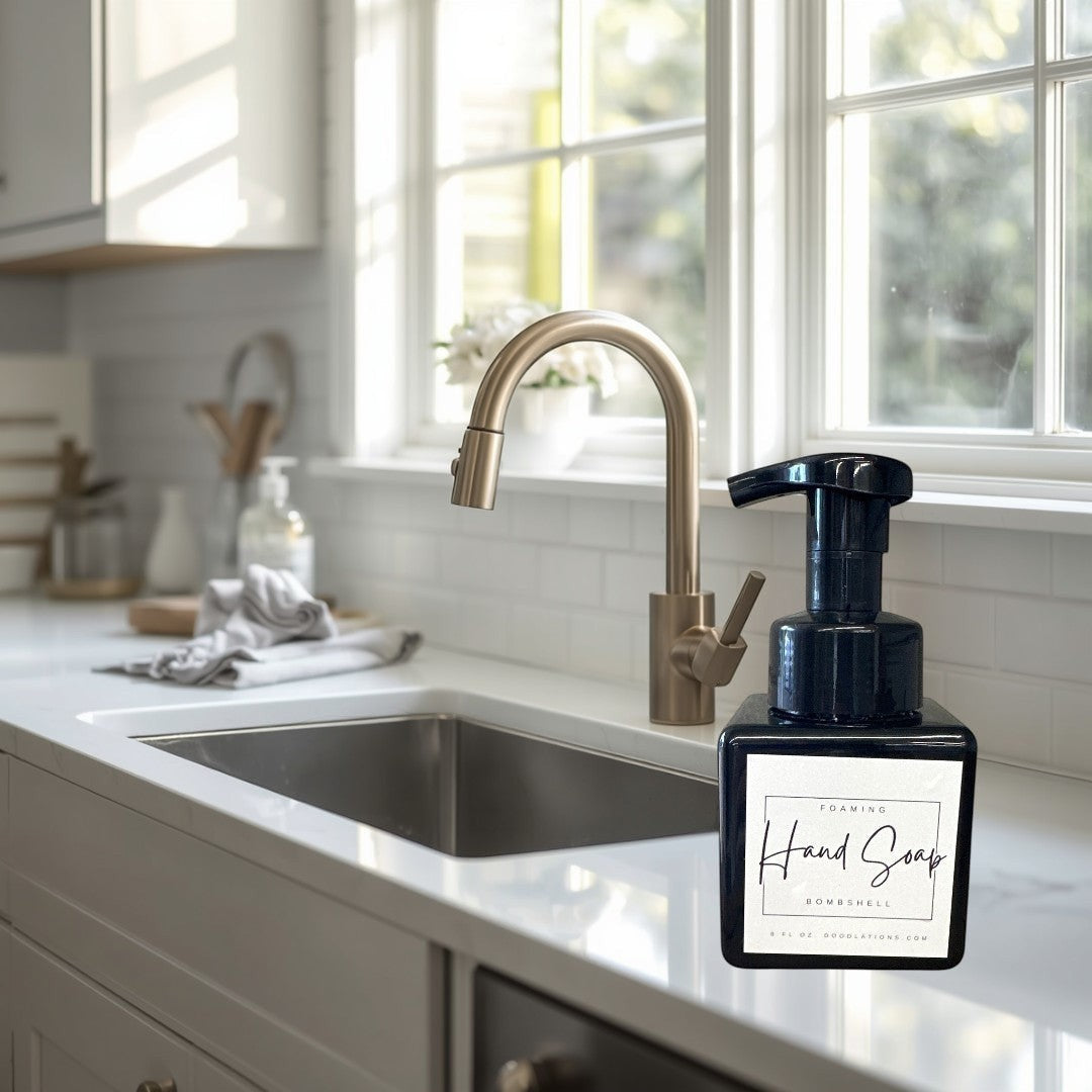 Doodlations Bombshell foaming hand soap in a black square bottle with a white label.