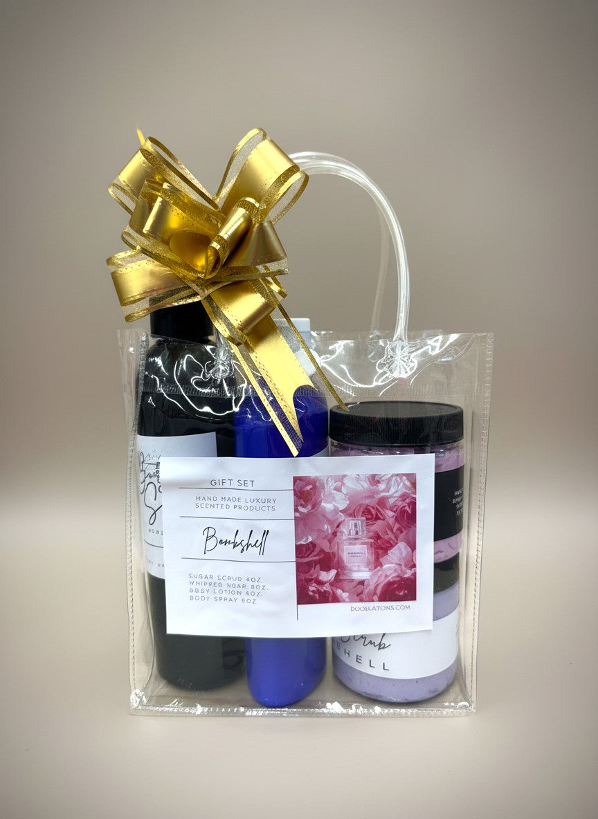 Doodlations Coffee Bar & Boutique Bombshell gift set with sugar scrub, whipped soap, body lotion, and body spray in a clear bag with a gold bow.