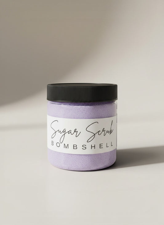 Doodlations Coffee Bar & Boutique Bombshell Sugar Scrub in a clear jar with a black lid. Lavender colored scrub.