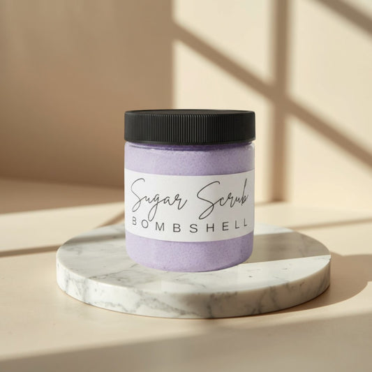 Doodlations Coffee Bar & Boutique Bombshell Sugar Scrub in a clear jar with a black lid. Lavender colored scrub.
