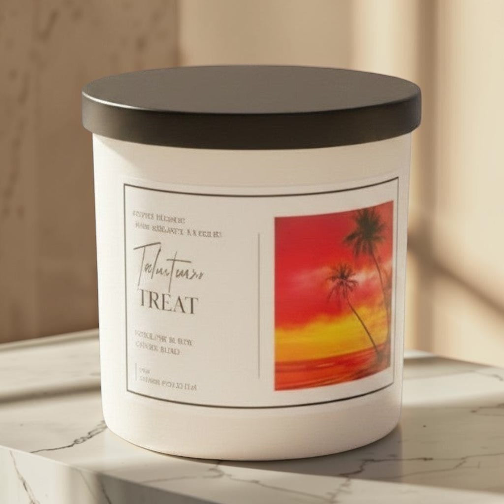 Doodlations Coffee Bar & Boutique Tahitian Treat candle with tropical sunset label, on a wooden table by a beach.