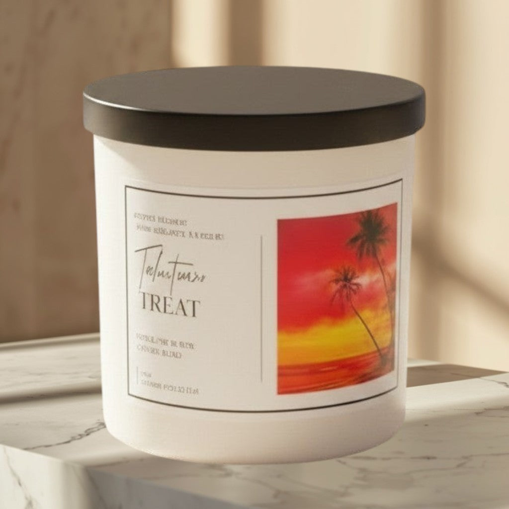 Doodlations Coffee Bar & Boutique Tahitian Treat candle with tropical sunset label, on a wooden table by a beach.