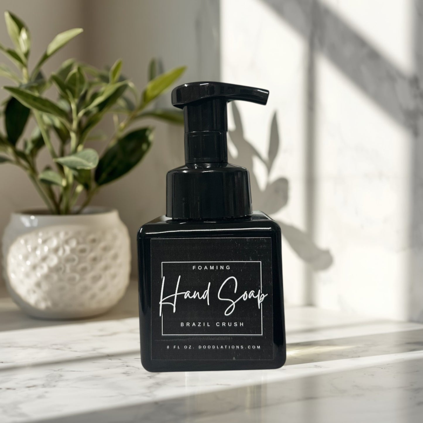 Doodlations Coffee Bar & Boutique black foaming hand soap bottle with 'Brazil Crush' label, 8 fl oz.