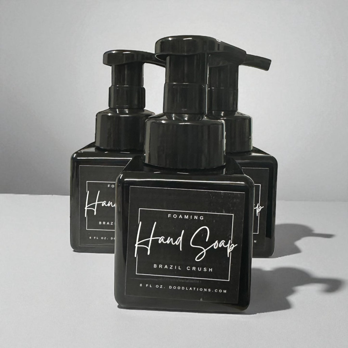 Doodlations Coffee Bar & Boutique Brazilian Crush foaming hand soap in black bottles with white labels.