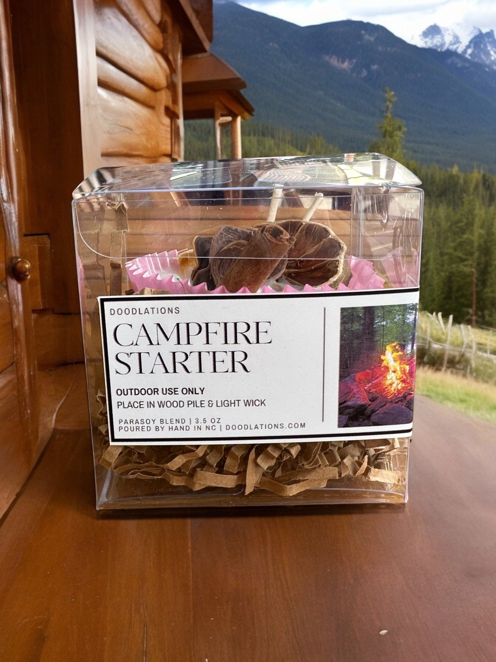 Doodlations campfire starters in a clear box, made with wax and a wick for outdoor use.