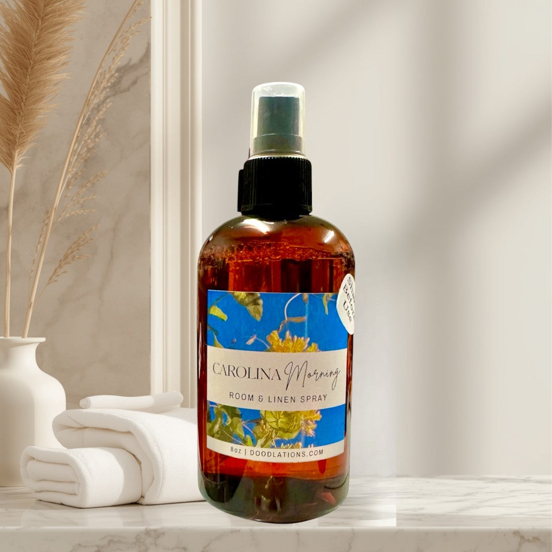 Doodlations Coffee Bar & Boutique Carolina Morning room and linen spray with honeysuckle and floral notes in amber bottle.