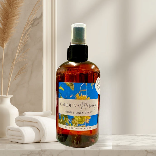 Doodlations Coffee Bar & Boutique Carolina Morning room and linen spray with honeysuckle and floral notes in amber bottle.