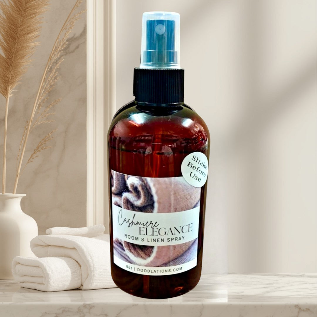 Doodlations Coffee Bar & Boutique Cashmere Elegance room and linen spray in amber bottle with a warm, inviting scent.
