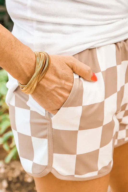 Doodlations Coffee Bar & Boutique taupe and white checkerboard print lounge shorts with side pockets and a drawstring.