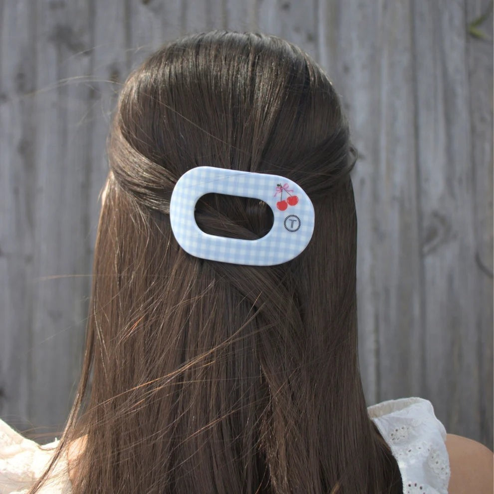 Doodlations Coffee Bar & Boutique light blue gingham hair clip with cherry design and secure hold.