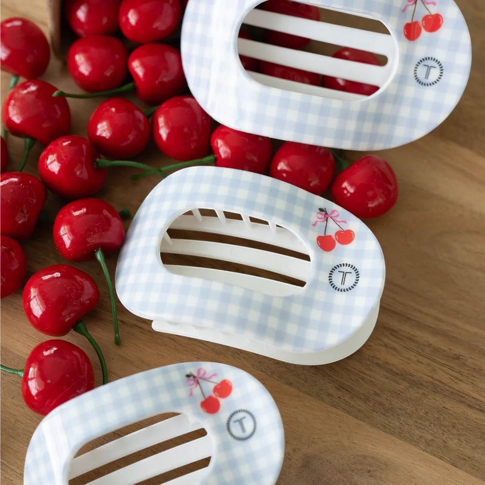Doodlations Coffee Bar & Boutique light blue gingham hair clip with cherry design and secure hold.