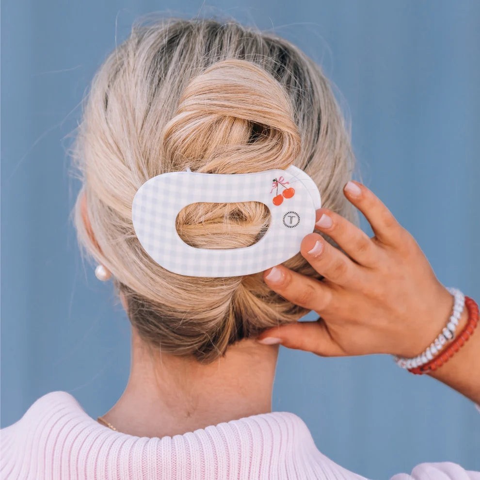 Doodlations Coffee Bar & Boutique cherry hair clip with light blue gingham pattern. Flat, round design.