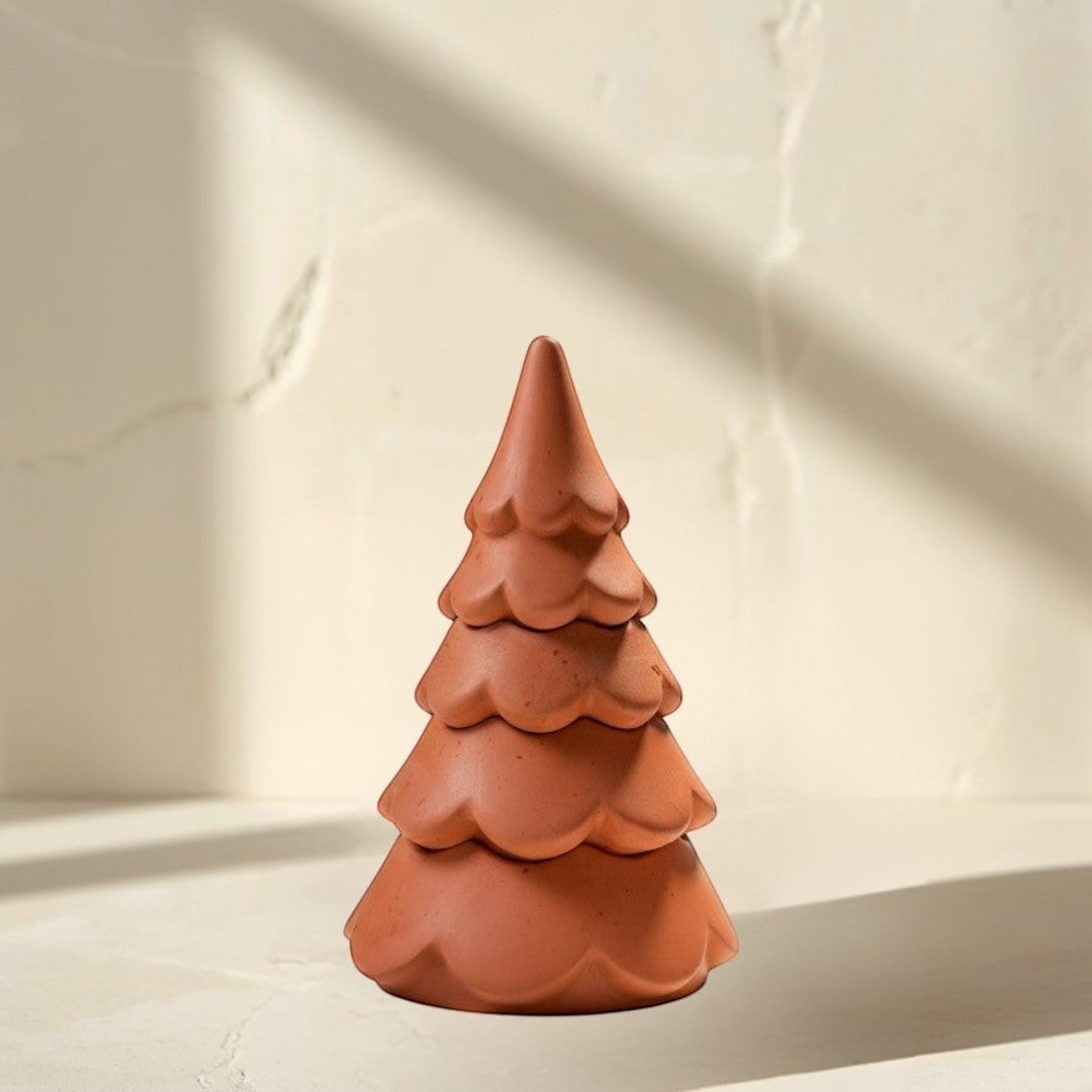 Doodlations 3-tier Christmas tree candle in terracotta concrete. Whimsical cloud design with festive charm.