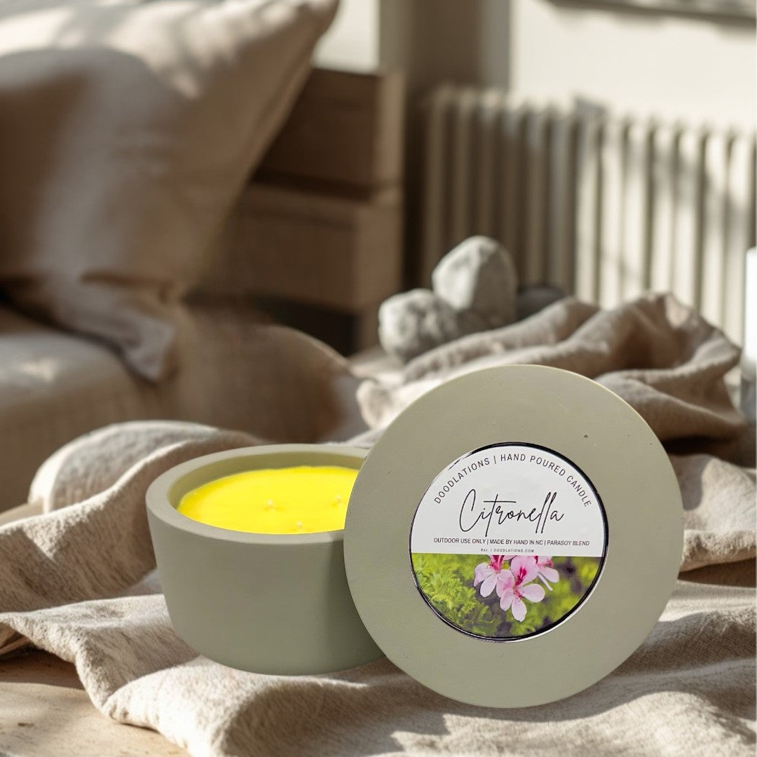 Doodlations 3-wick citronella candle in a grey concrete vessel with yellow soy blend wax. Outdoor decor.