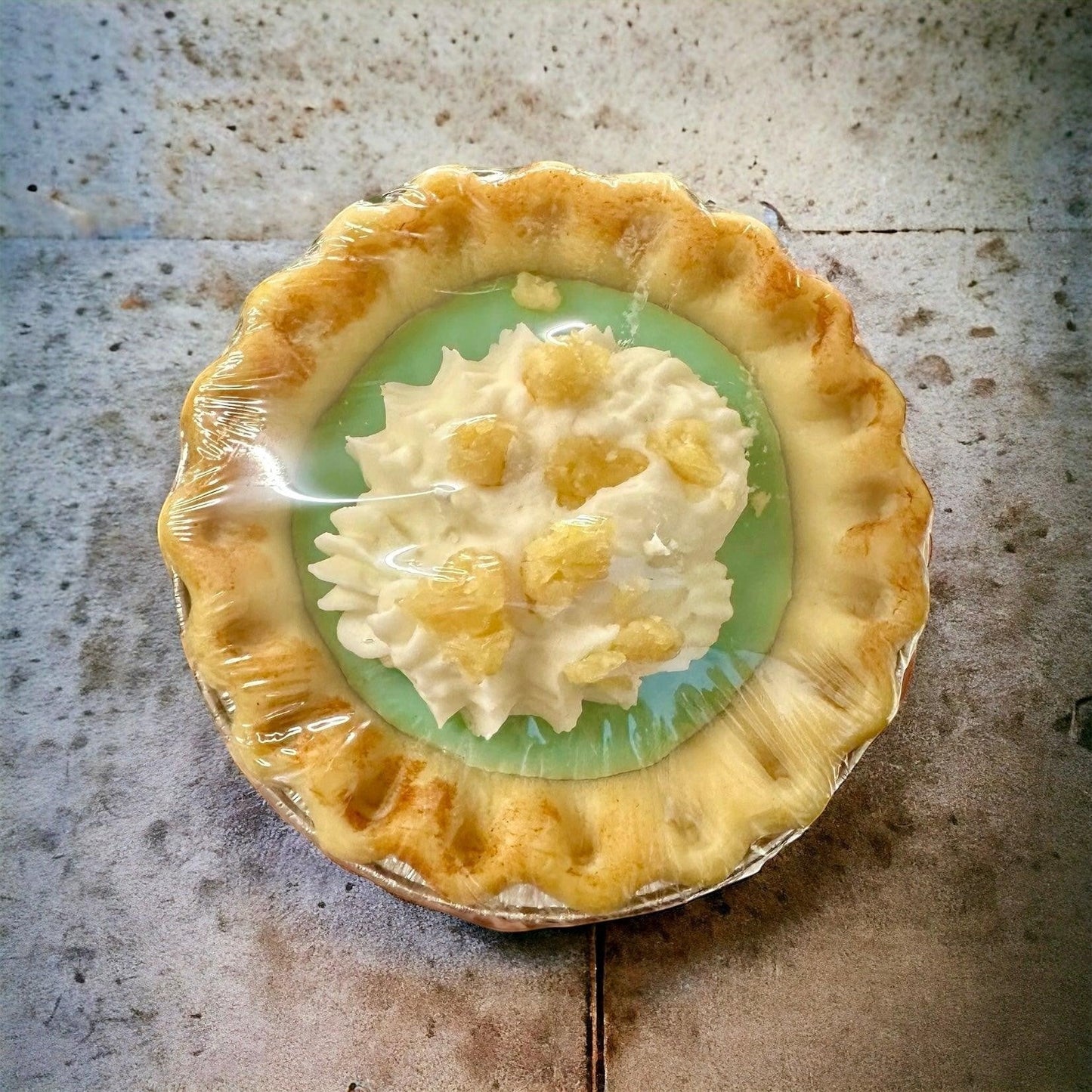 Doodlations Coffee Bar & Boutique individual creamy citrus tart with whipped cream and candied peel.