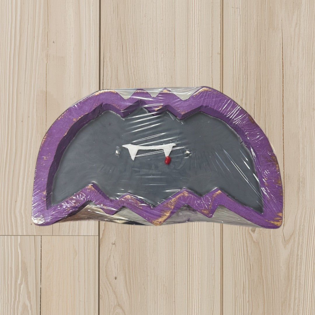 Doodlations Coffee Bar & Boutique Bat Dough Bowl Candle with vampire fangs and a red drop.