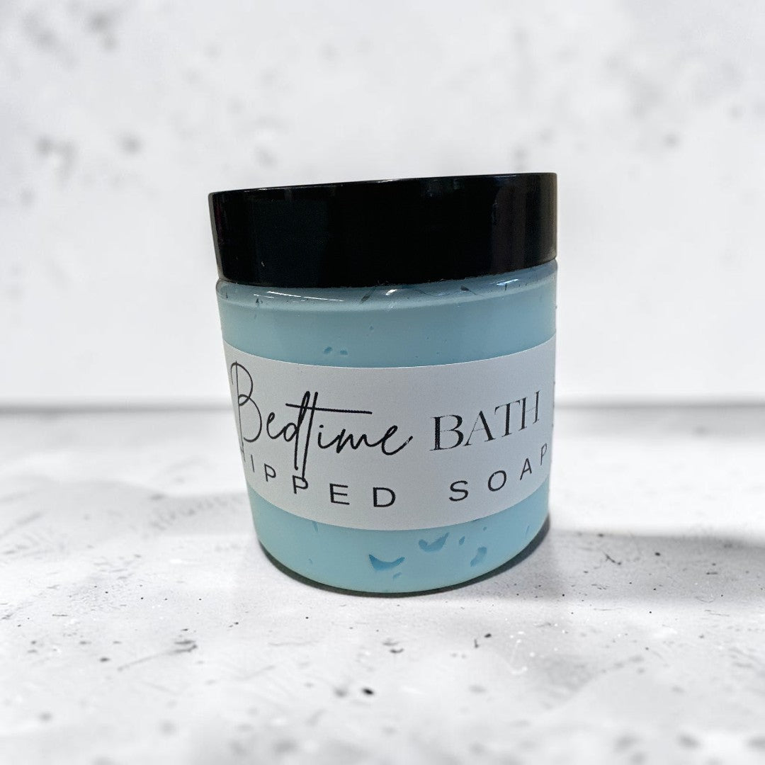 Doodlations Coffee Bar & Boutique Bedtime Bath whipped soap in a light blue jar with a black lid.