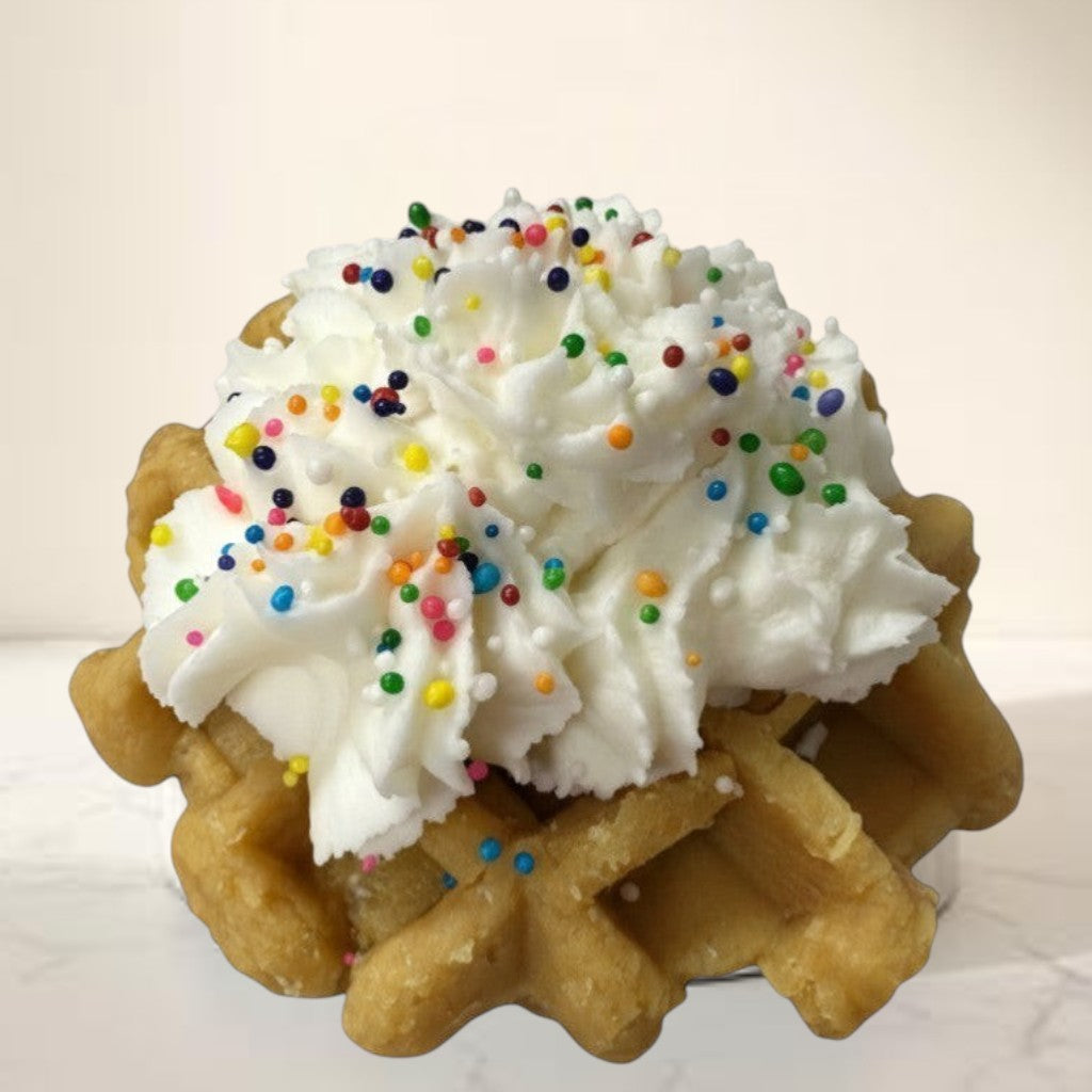 Doodlations Coffee Bar & Boutique Birthday Cake Waffle wax melt topped with whipped cream and colorful sprinkles.