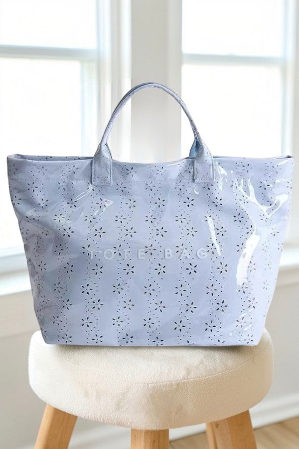 Doodlations Coffee Bar & Boutique baby blue PVC tote bag with a glossy finish and delicate floral eyelet pattern.