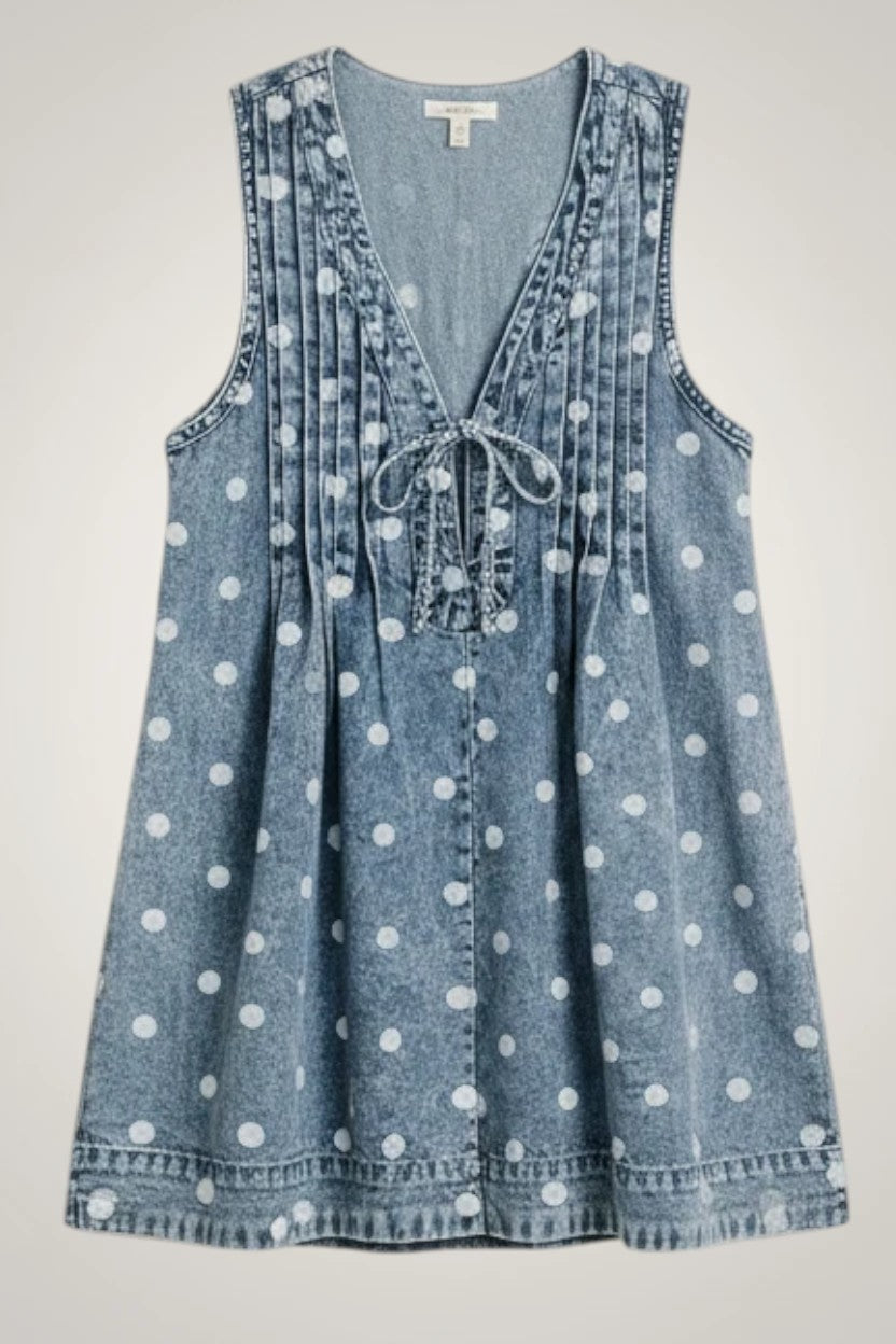Doodlations Coffee Bar & Boutique blue denim romper with white polka dots, V-neck, tie front, and pleated details.
