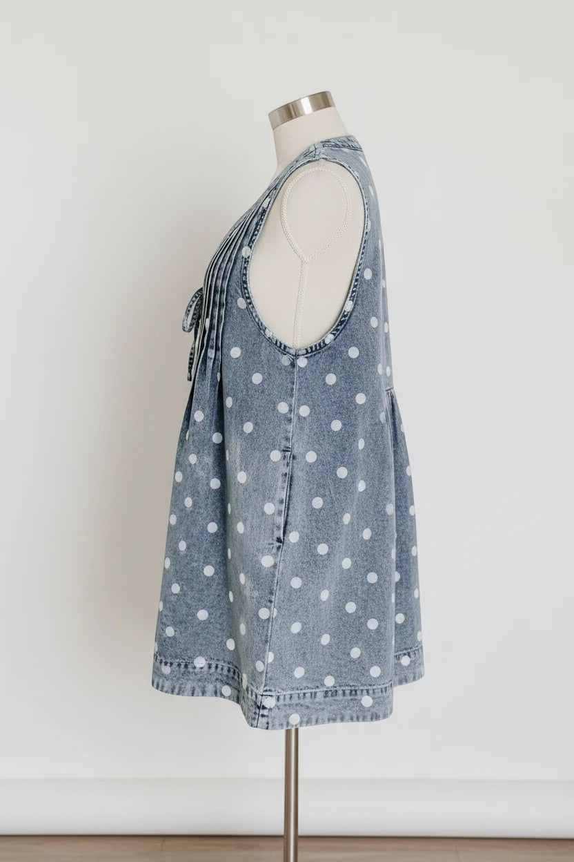 Doodlations Coffee Bar & Boutique blue denim romper with white polka dots, tie neck, and pleated front.