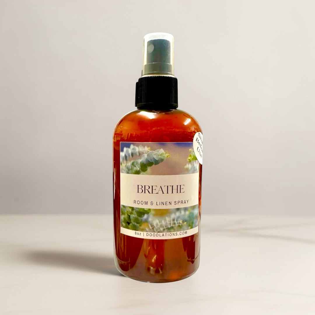 Doodlations Coffee Bar & Boutique Breathe room and linen spray in amber glass bottle with eucalyptus leaf label.