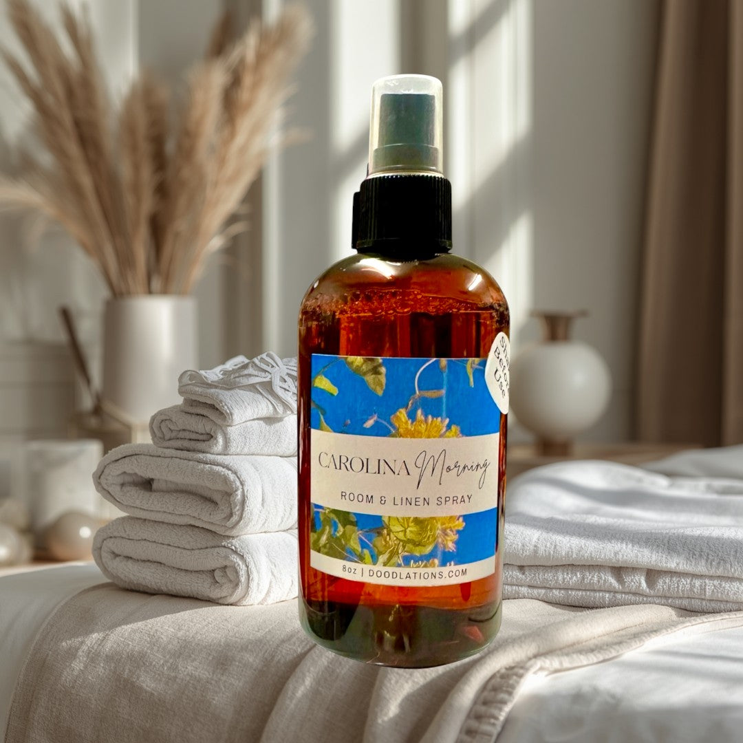 Doodlations Coffee Bar & Boutique Carolina Morning room and linen spray in amber glass bottle with floral label.