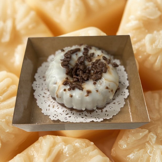 Doodlations Coffee Bar & Boutique Chocolate Pound Cake wax melt, white icing with chocolate shavings, bundt cake shape.