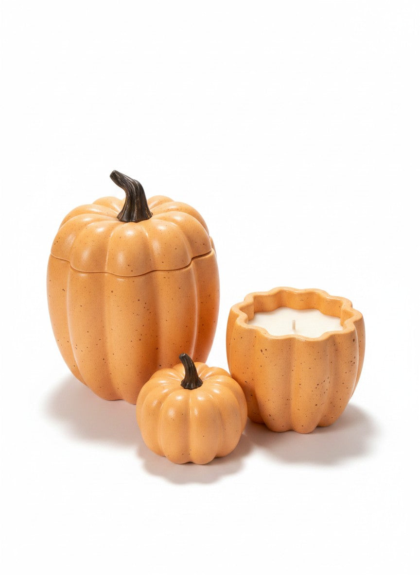 Doodlations Coffee Bar & Boutique orange concrete pumpkin candles in various sizes, perfect for fall decor.