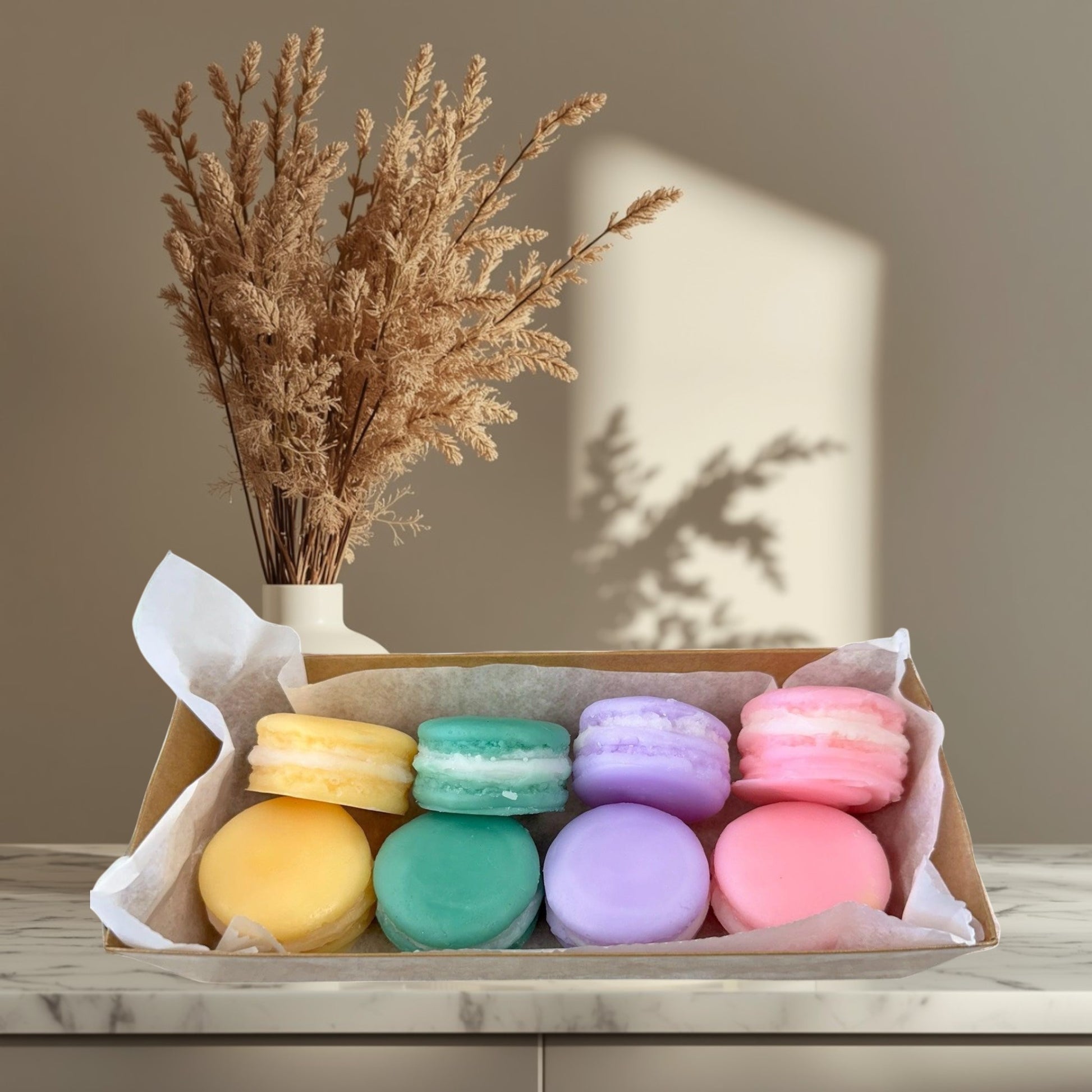 Doodlations Coffee Bar & Boutique Easter Macaroon Wax Melts in pastel yellow, teal, lavender, and pink.