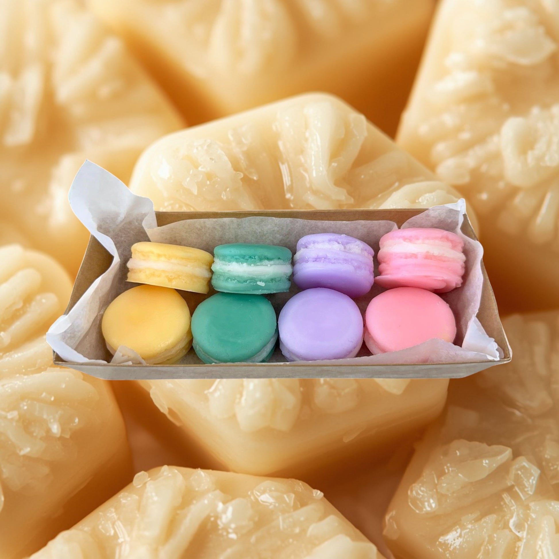 Doodlations Coffee Bar & Boutique Easter Macaroon Wax Melts in pastel yellow, teal, lavender, and pink, shaped like macarons.
