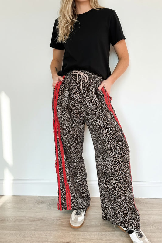 Doodlations Coffee Bar & Boutique Leopard Print Striped Drawstring Pants with red side stripe detail and adjustable waist.