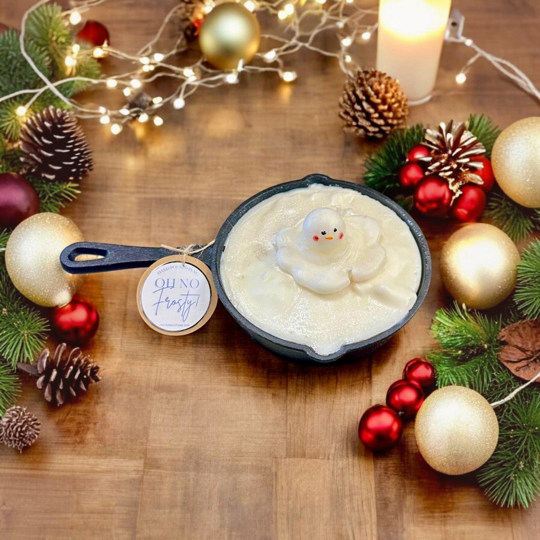 Doodlations Coffee Bar & Boutique Melting Snowman Skillet Candle, a whimsical holiday candle with a melting snowman figure in creamy white wax.