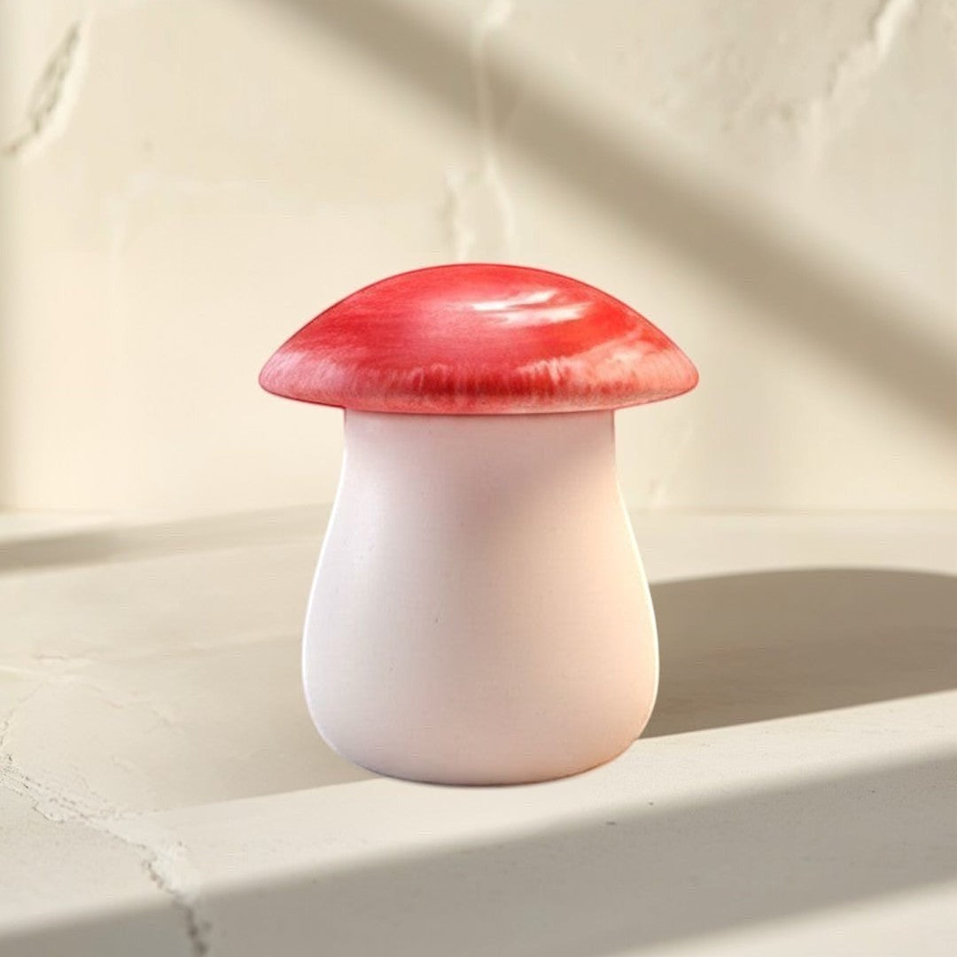 Doodlations Coffee Bar & Boutique mushroom concrete candle with red swirled lid and salted honey scent.