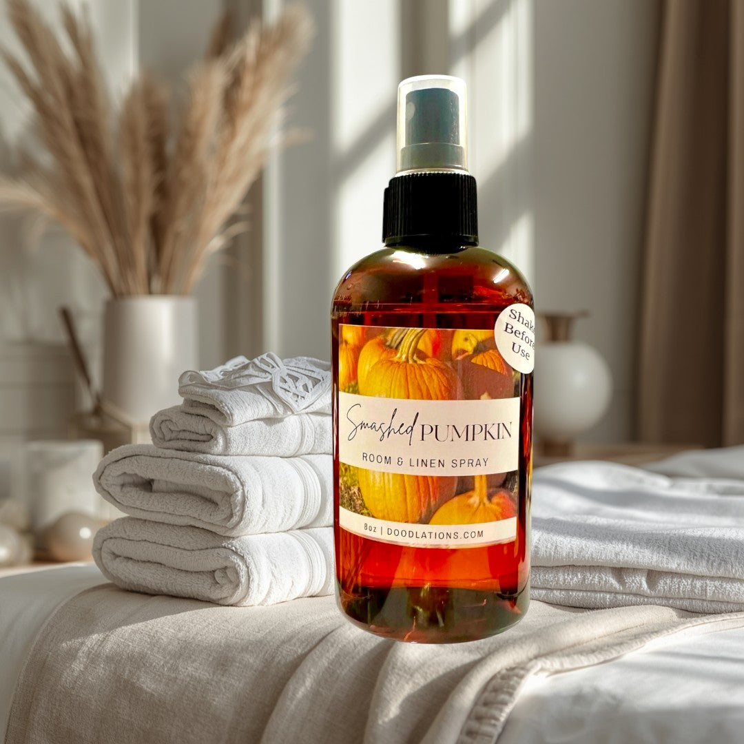 Doodlations Coffee Bar & Boutique Smashed Pumpkin Room & Linen Spray, amber bottle with pumpkins on label.