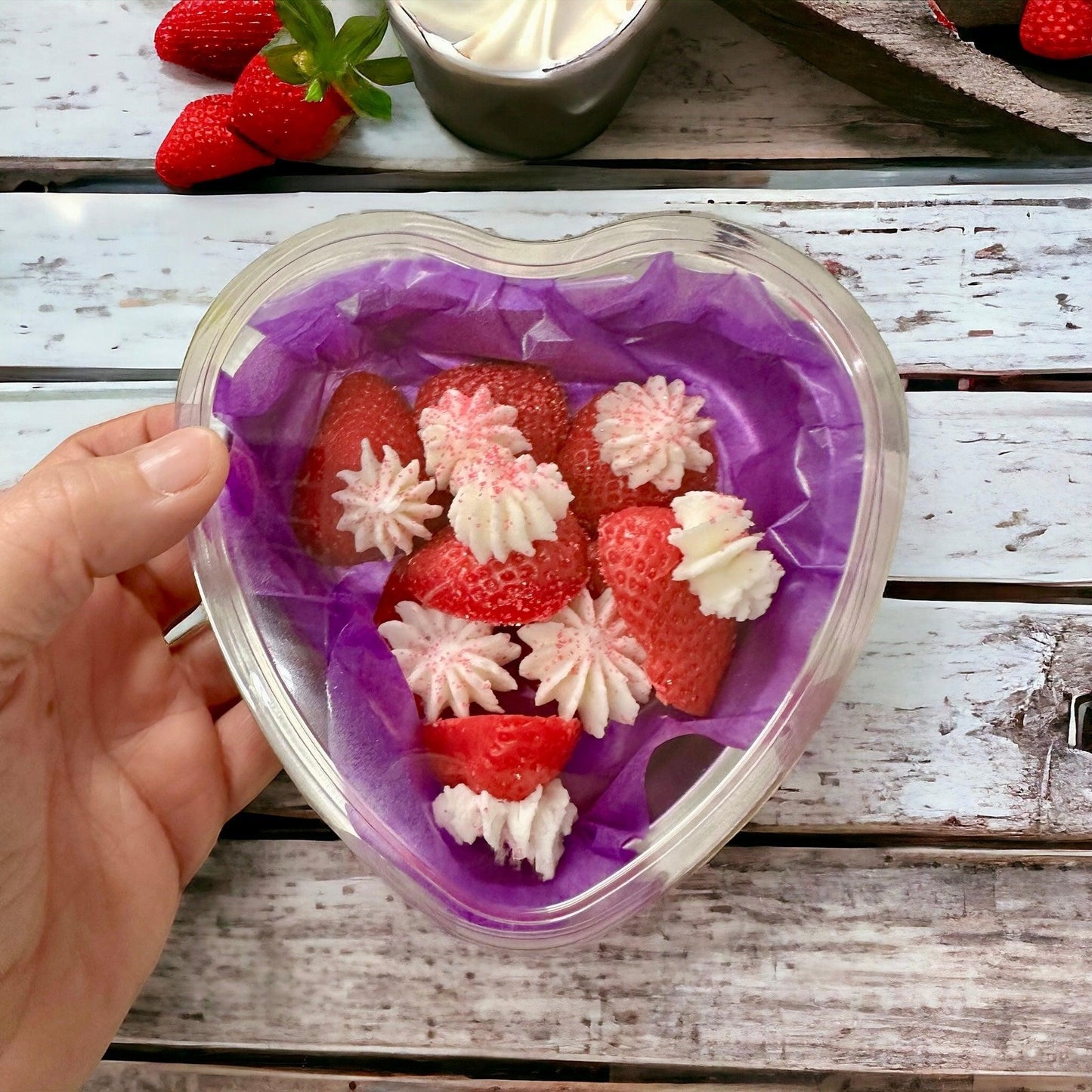 Doodlations Coffee Bar & Boutique heart-shaped wax melts with strawberry and cream design.