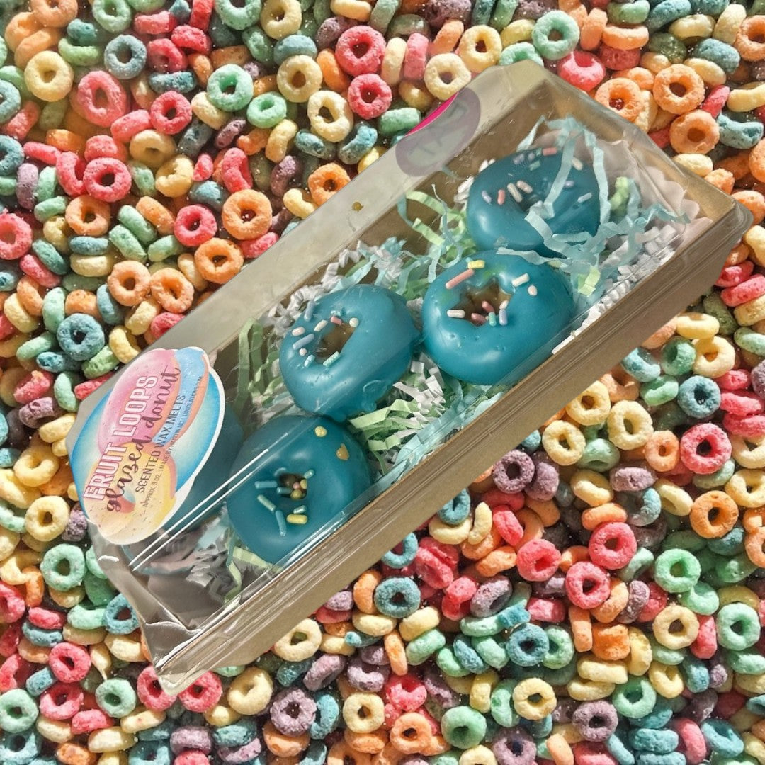 Doodlations Coffee Bar & Boutique teal glazed donut wax melts with colorful sprinkles, shaped like donuts.