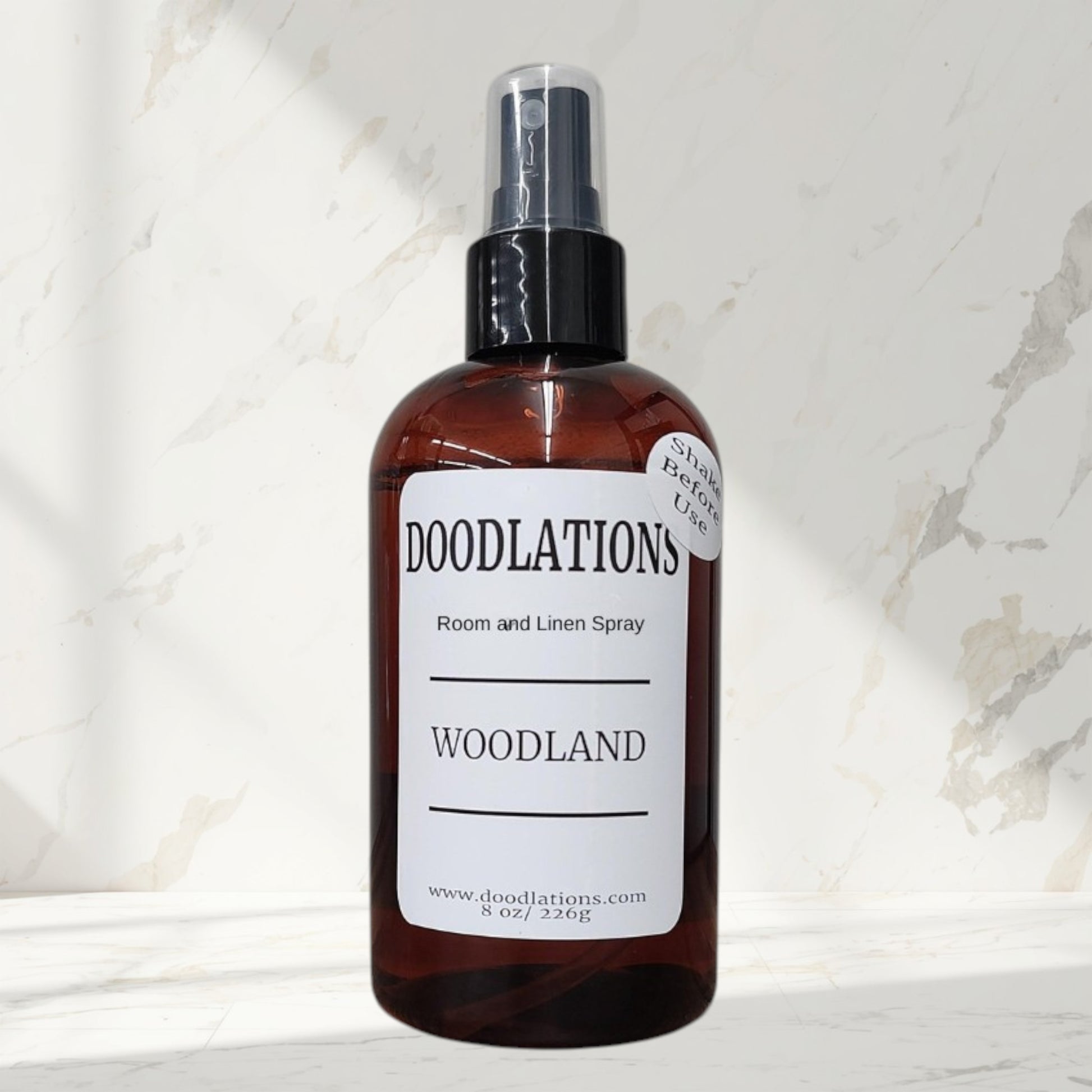 Doodlations Coffee Bar & Boutique Woodland room and linen spray in amber bottle with white label. 8 oz.