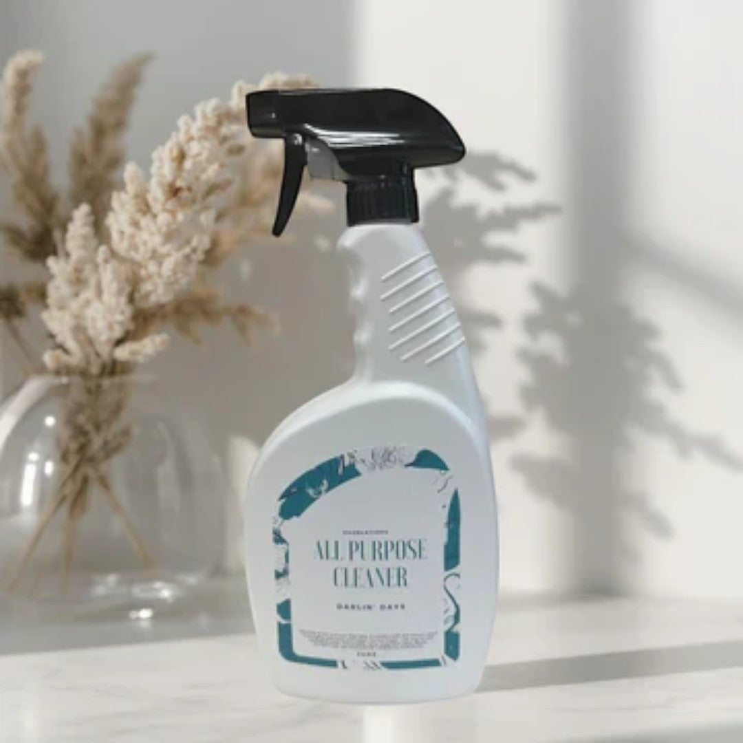 Doodlations Coffee Bar & Boutique All Purpose Cleaning Spray bottle with a dark teal label and white text.