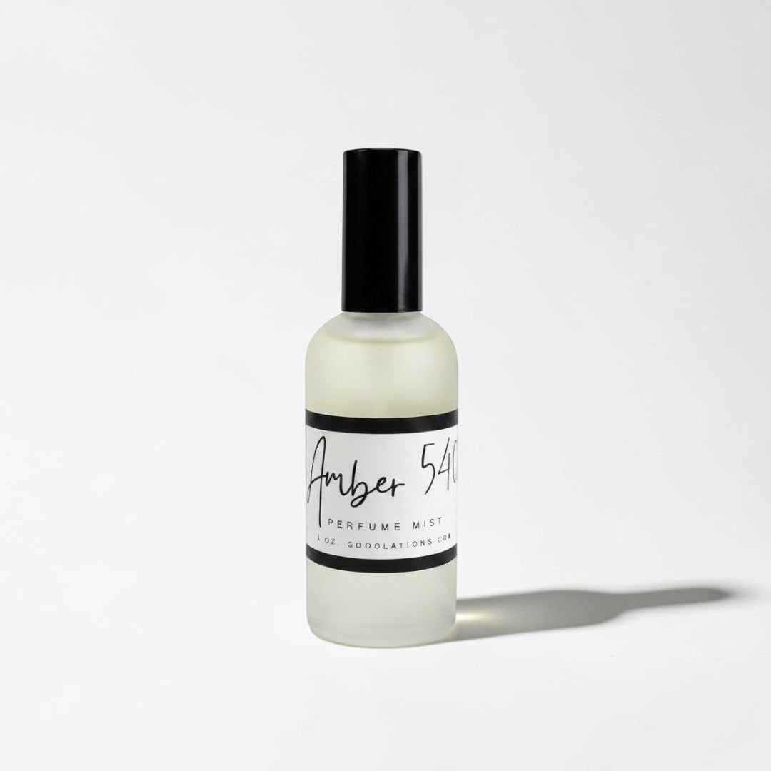 Doodlations Coffee Bar & Boutique Amber 540 fine mist perfume in a sleek frosted glass bottle with a black cap.