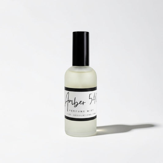 Doodlations Coffee Bar & Boutique Amber 540 fine mist perfume in a sleek frosted glass bottle with a black cap.