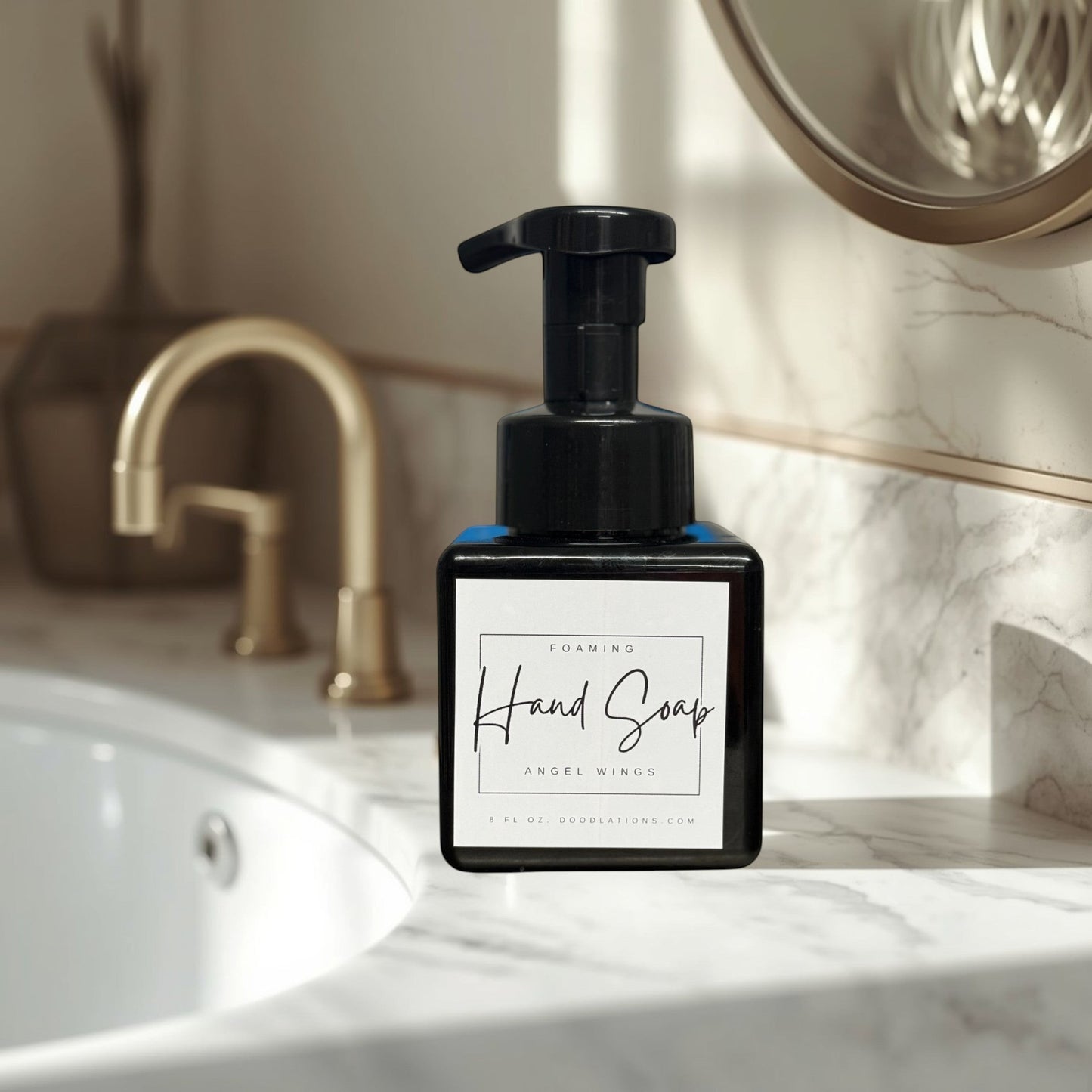 Doodlations Coffee Bar & Boutique Angel Wings foaming hand soap in a black bottle with a white label.