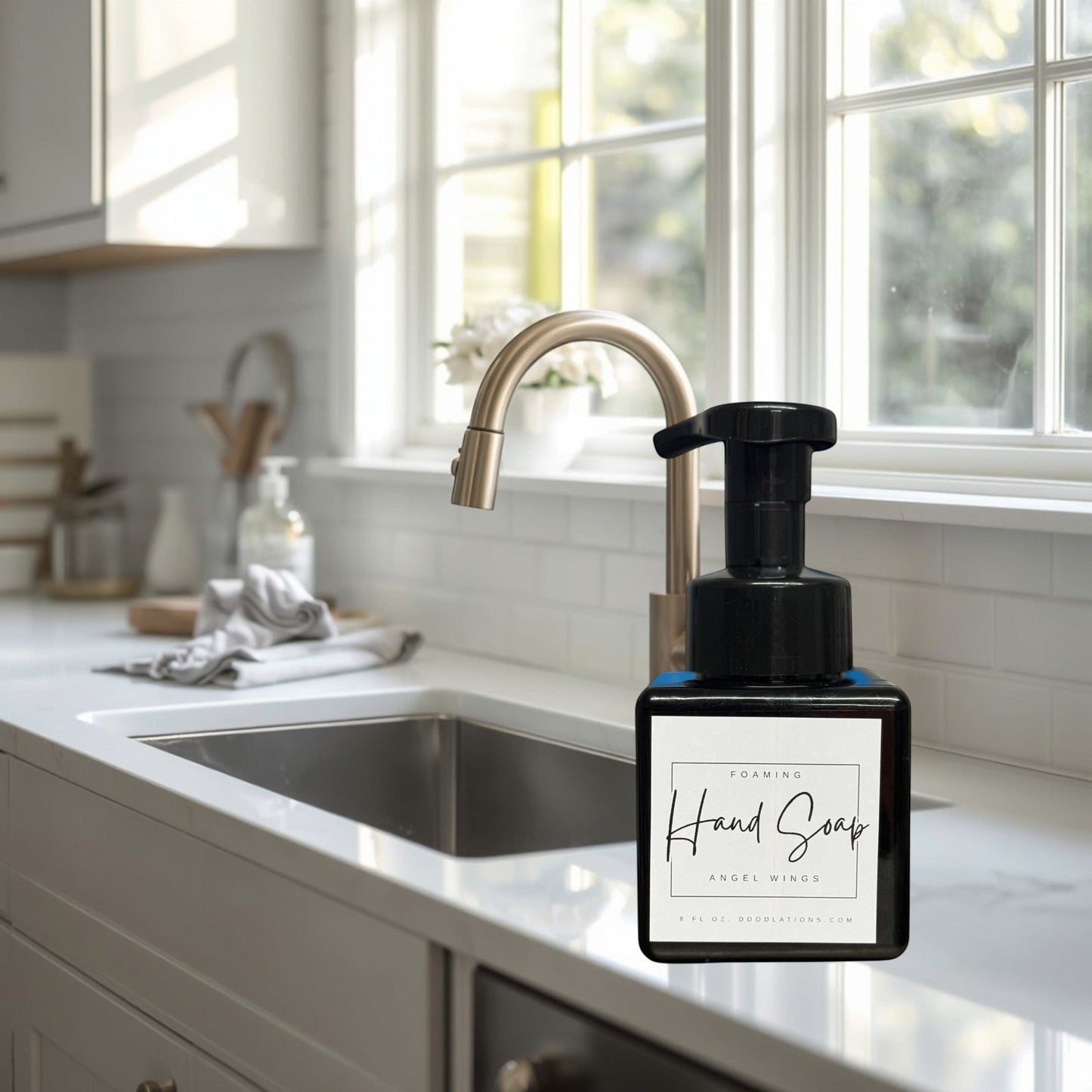 Doodlations Coffee Bar & Boutique Angel Wings foaming hand soap in a black bottle with a white label.