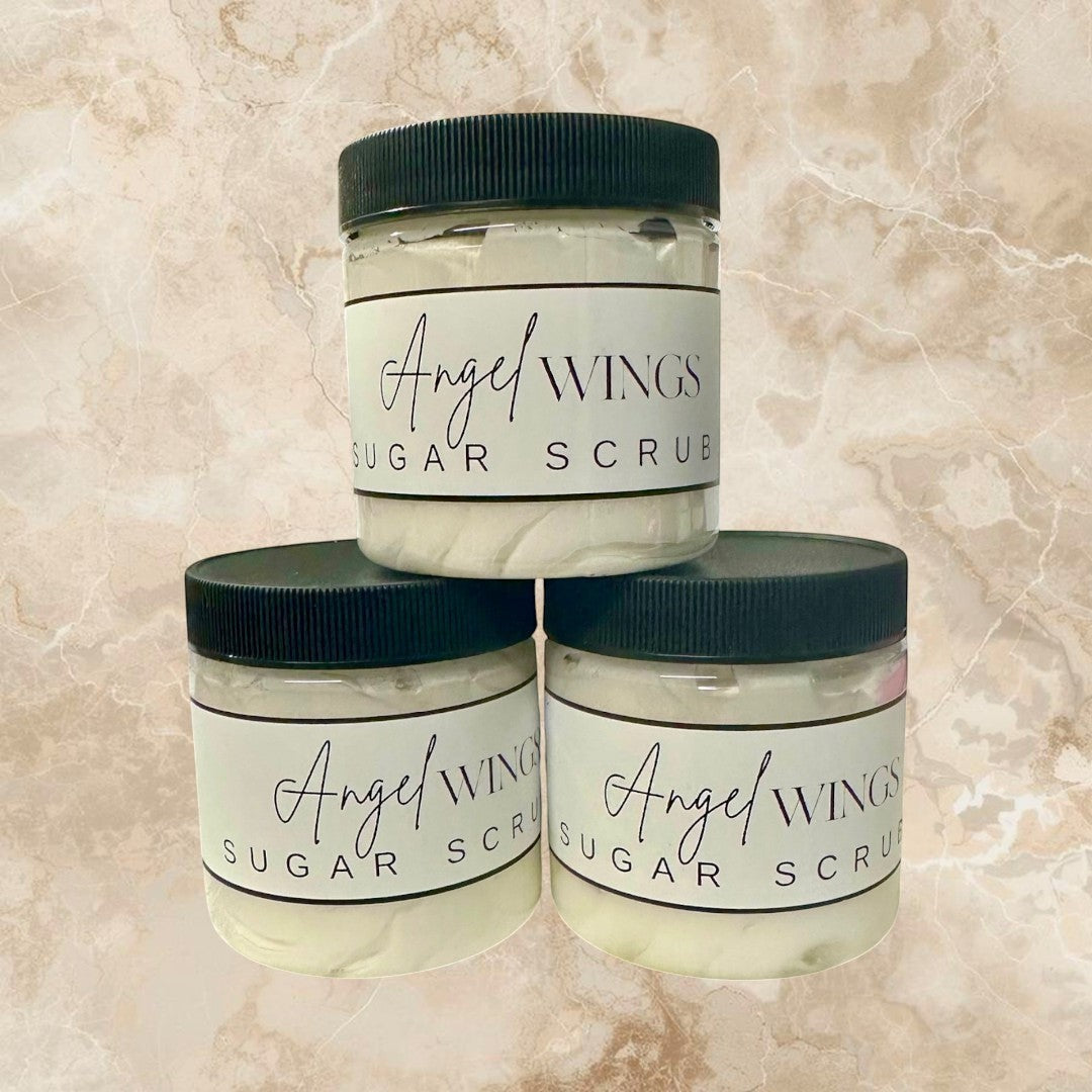 Doodlations Coffee Bar & Boutique Angel Wings sugar scrub in clear jars with black lids. White scrub with flecks of color.
