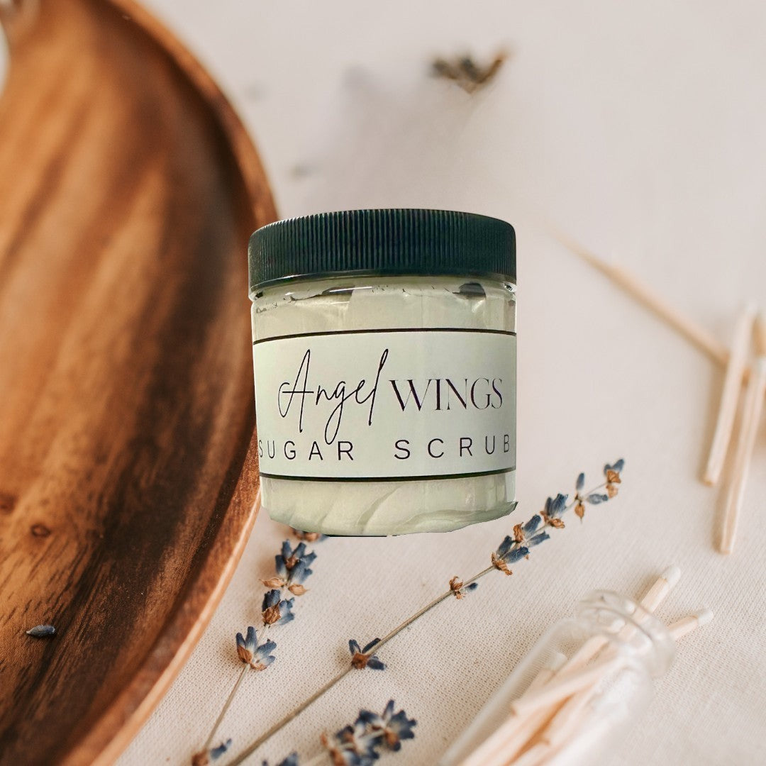 Doodlations Coffee Bar & Boutique Angel Wings sugar scrub in clear jars with black lids. White scrub with visible sugar crystals.