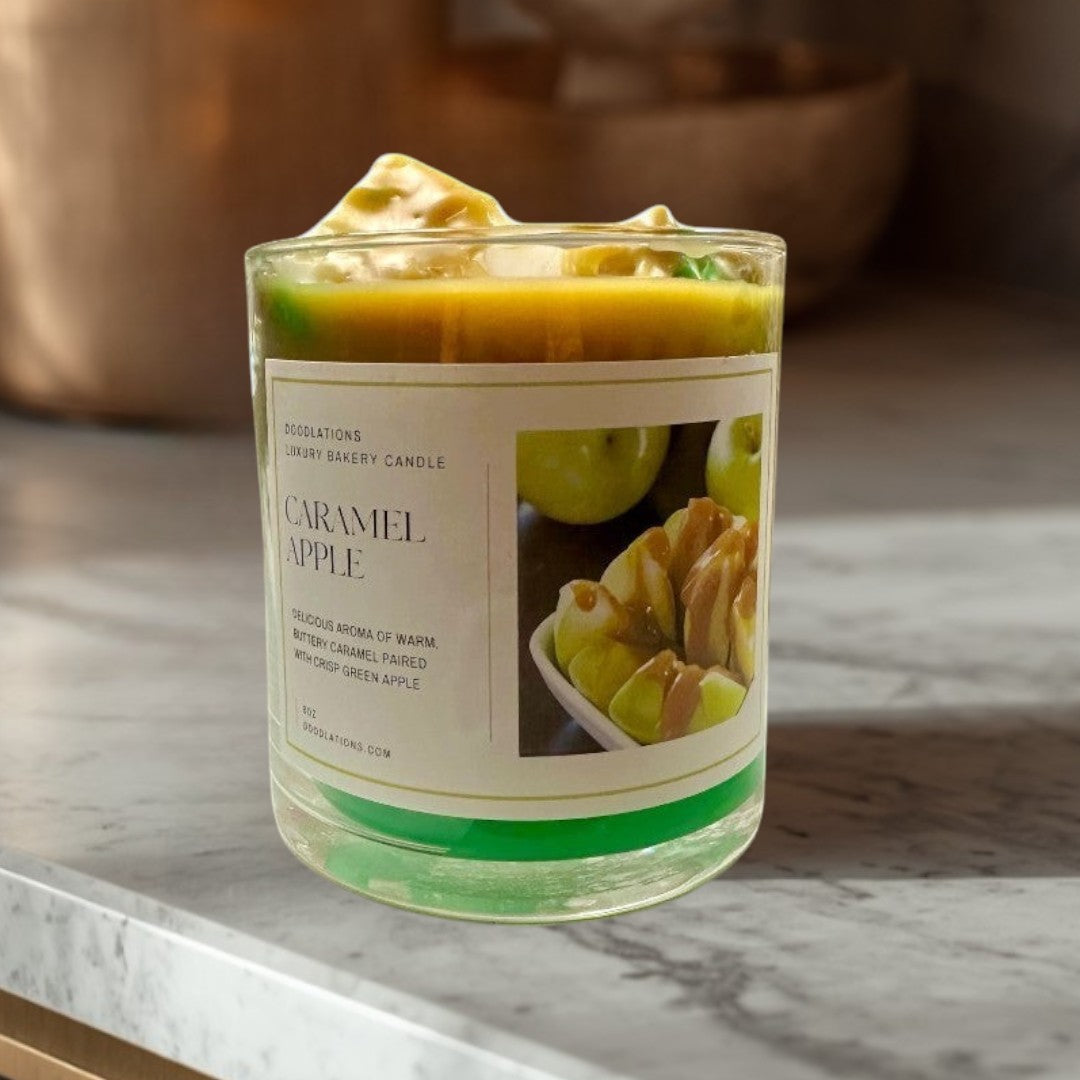 Doodlations Coffee Bar & Boutique Apple Caramel Candle with green wax base and caramel-topped apple slices on label.