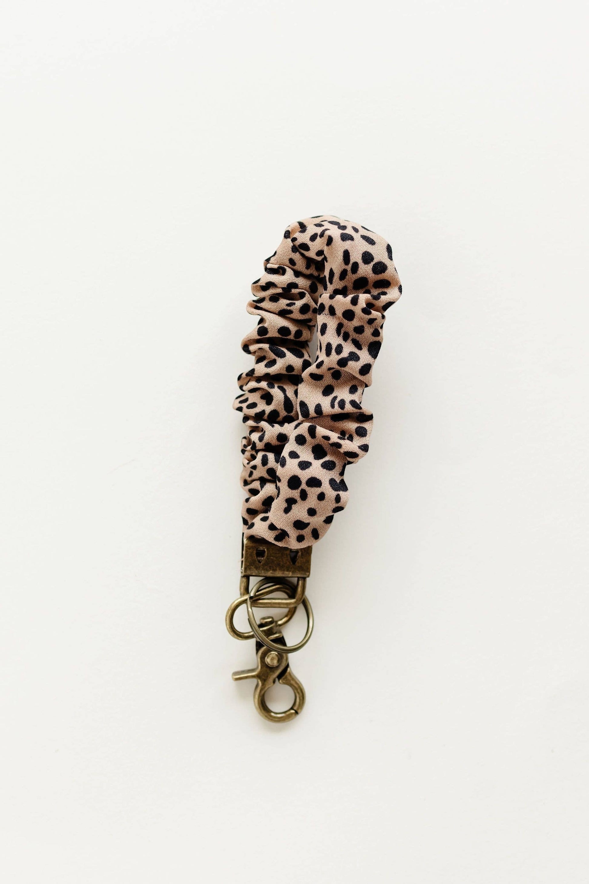 Doodlations Coffee Bar & Boutique apricot terracotta jungle cat print fabric keychain with bronze metal hardware