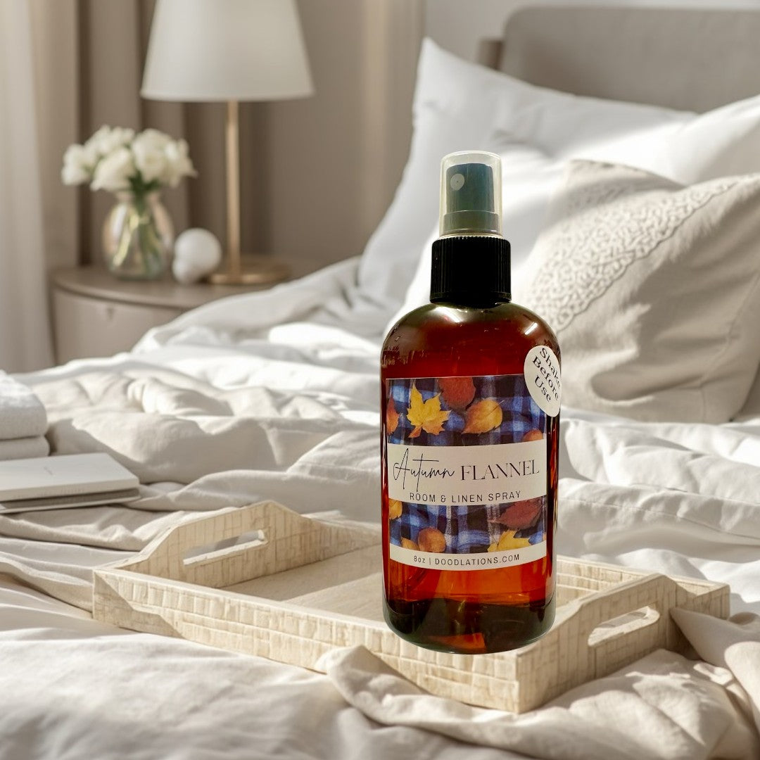 Doodlations Coffee Bar & Boutique Autumn Flannel room and linen spray in amber bottle with fall leaf label.